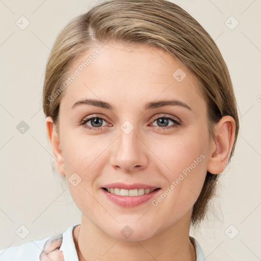 Joyful white young-adult female with medium  brown hair and blue eyes