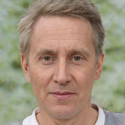 Joyful white middle-aged male with short  brown hair and brown eyes