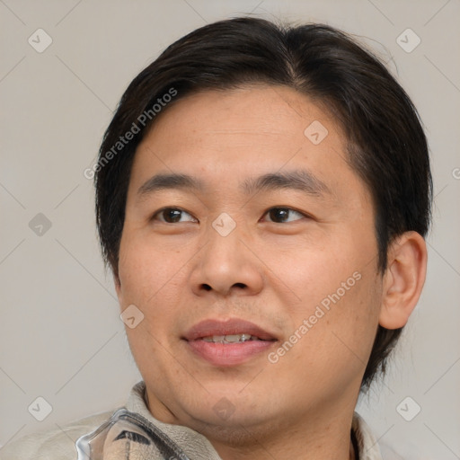 Joyful white adult male with short  brown hair and brown eyes
