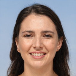 Joyful white adult female with long  brown hair and brown eyes