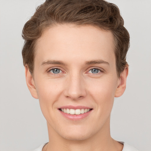 Joyful white young-adult female with short  brown hair and grey eyes