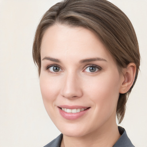 Joyful white young-adult female with medium  brown hair and grey eyes