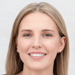 Joyful white young-adult female with long  brown hair and grey eyes