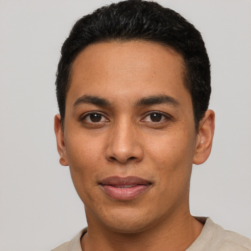 Joyful latino young-adult male with short  black hair and brown eyes