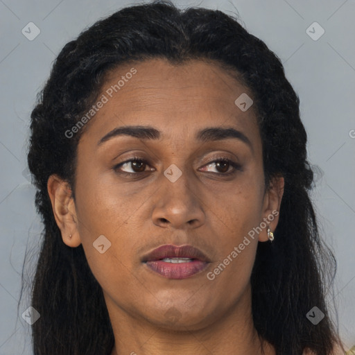 Joyful black adult female with long  brown hair and brown eyes