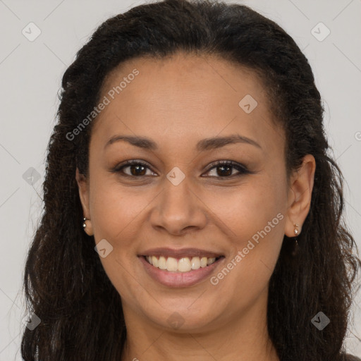 Joyful black young-adult female with long  brown hair and brown eyes