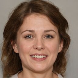 Joyful white adult female with medium  brown hair and brown eyes