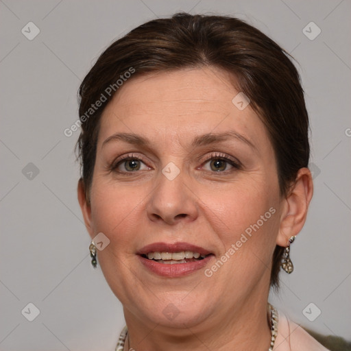 Joyful white adult female with medium  brown hair and grey eyes