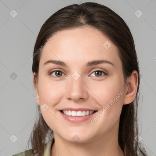 Joyful white young-adult female with long  brown hair and grey eyes