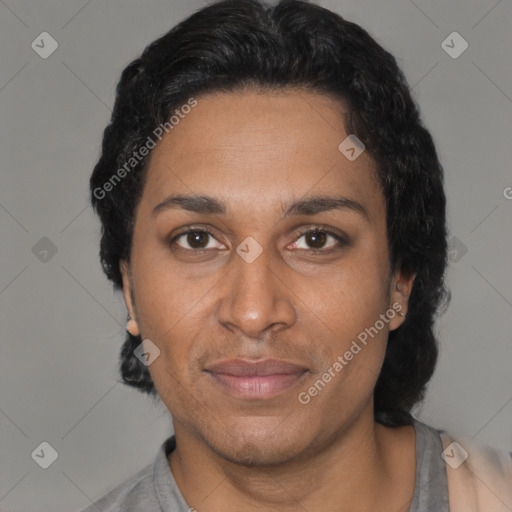 Joyful black adult female with short  black hair and brown eyes