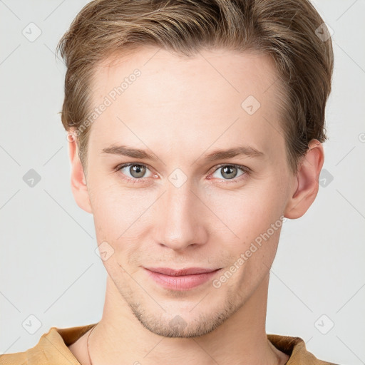 Joyful white young-adult male with short  brown hair and grey eyes