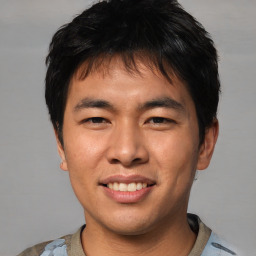 Joyful asian young-adult male with short  black hair and brown eyes