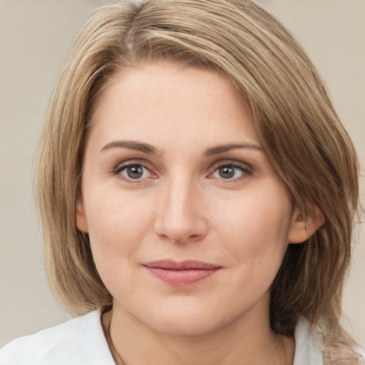 Joyful white young-adult female with medium  brown hair and green eyes