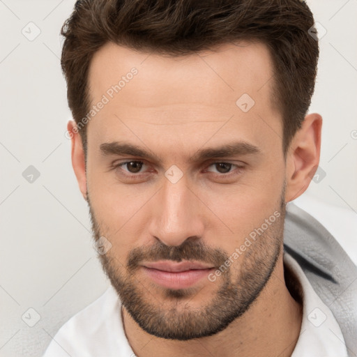 Joyful white young-adult male with short  brown hair and brown eyes