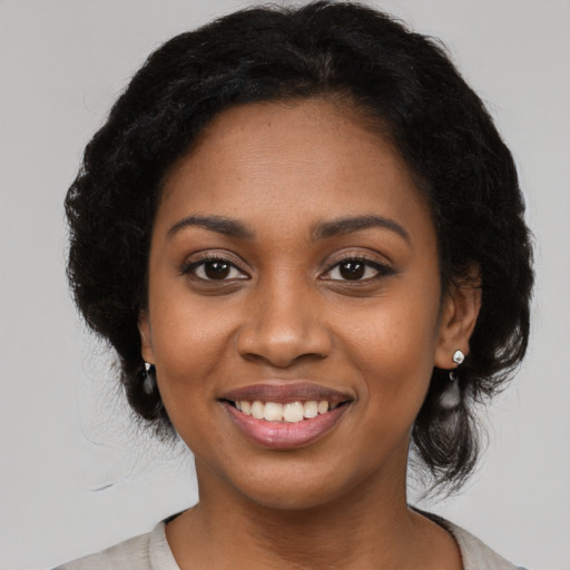 Joyful black young-adult female with medium  black hair and brown eyes