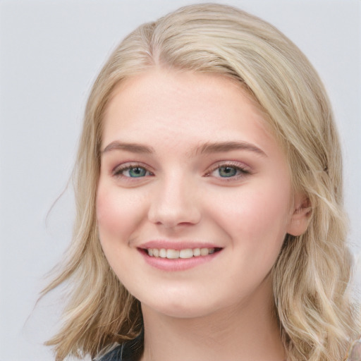 Joyful white young-adult female with long  brown hair and blue eyes