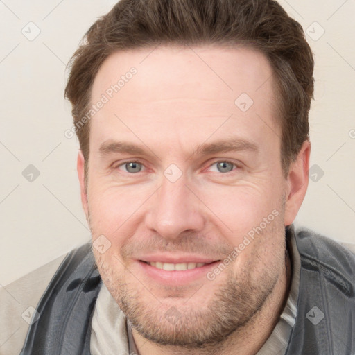 Joyful white adult male with short  brown hair and grey eyes