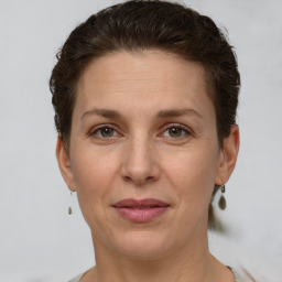 Joyful white adult female with short  brown hair and grey eyes