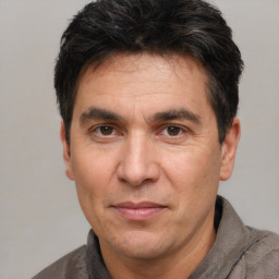 Joyful white adult male with short  black hair and brown eyes