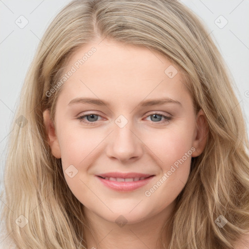 Joyful white young-adult female with long  brown hair and blue eyes