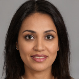 Joyful white young-adult female with long  brown hair and brown eyes