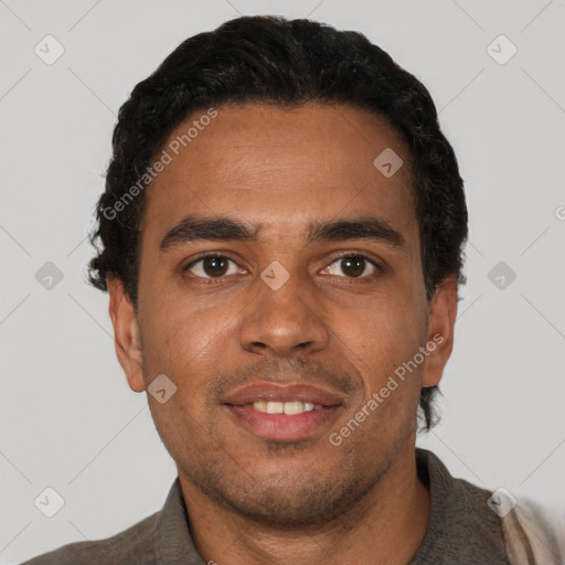 Joyful black young-adult male with short  black hair and brown eyes