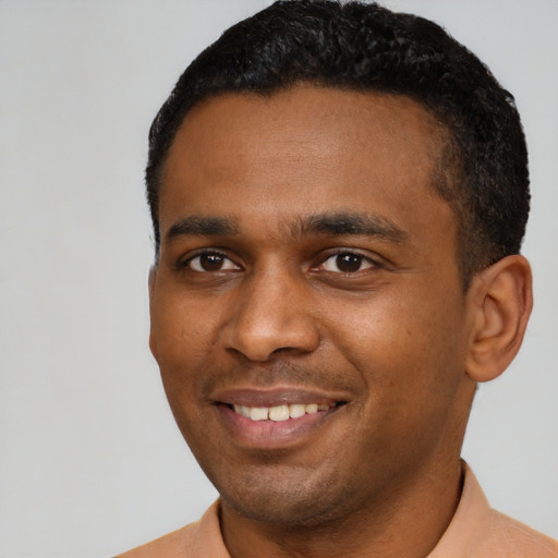 Joyful latino young-adult male with short  black hair and brown eyes