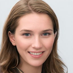 Joyful white young-adult female with long  brown hair and blue eyes