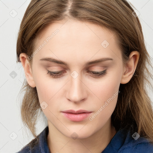 Joyful white young-adult female with long  brown hair and blue eyes