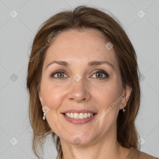 Joyful white adult female with medium  brown hair and grey eyes