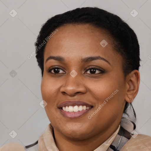 Joyful black young-adult female with short  black hair and brown eyes