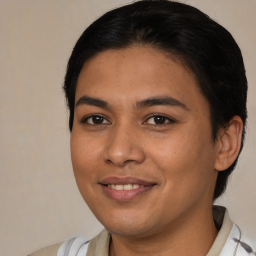 Joyful latino young-adult female with medium  brown hair and brown eyes