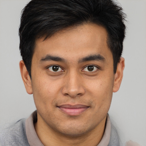 Joyful asian young-adult male with short  brown hair and brown eyes