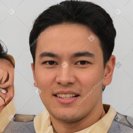 Joyful asian young-adult male with short  brown hair and brown eyes