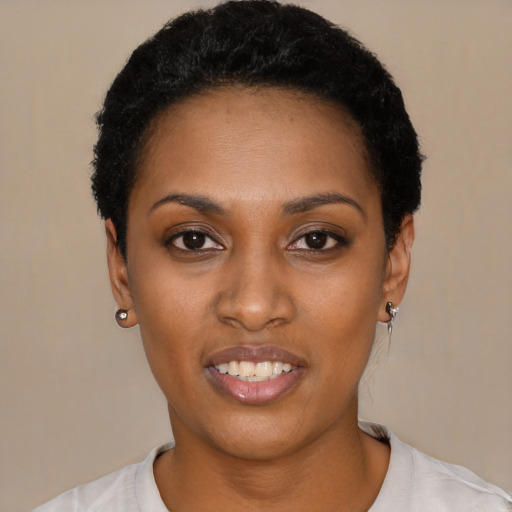 Joyful black young-adult female with short  black hair and brown eyes