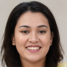 Joyful latino young-adult female with long  brown hair and brown eyes