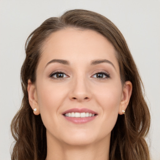 Joyful white young-adult female with long  brown hair and grey eyes