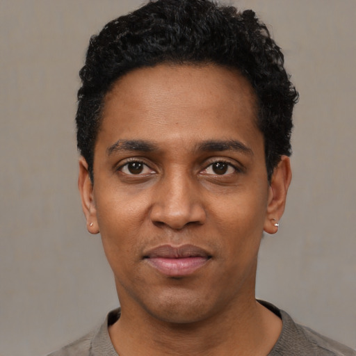 Neutral black adult male with short  black hair and brown eyes