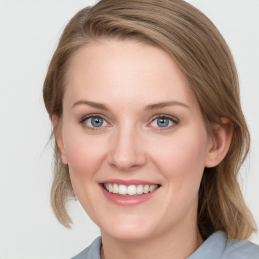 Joyful white young-adult female with medium  brown hair and blue eyes