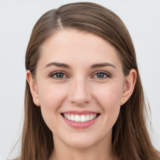 Joyful white young-adult female with long  brown hair and grey eyes