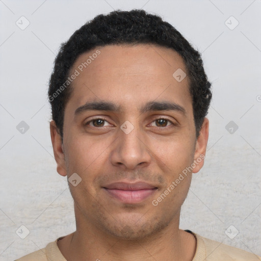 Joyful latino young-adult male with short  black hair and brown eyes