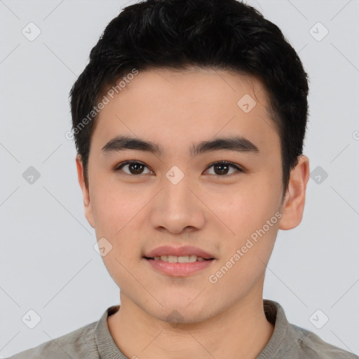 Joyful asian young-adult male with short  black hair and brown eyes