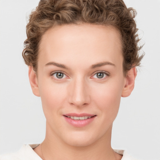 Joyful white young-adult female with short  brown hair and green eyes