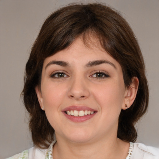 Joyful white young-adult female with medium  brown hair and brown eyes