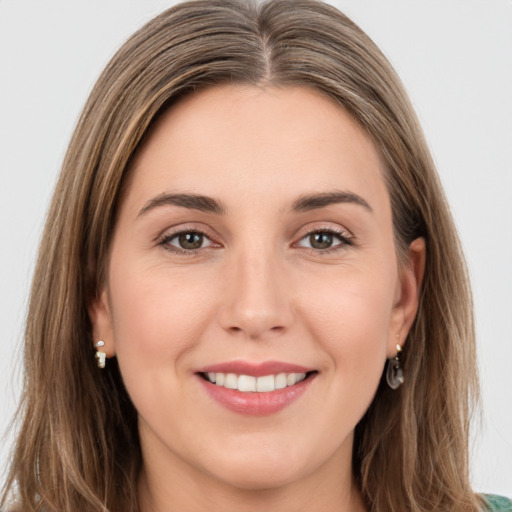 Joyful white young-adult female with long  brown hair and green eyes