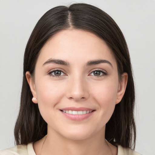 Joyful white young-adult female with medium  brown hair and brown eyes