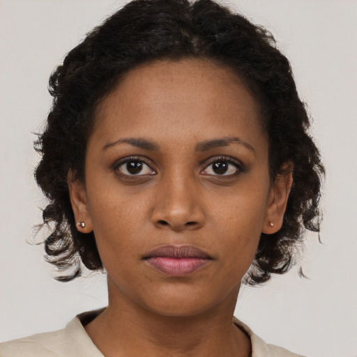 Neutral black young-adult female with medium  brown hair and brown eyes