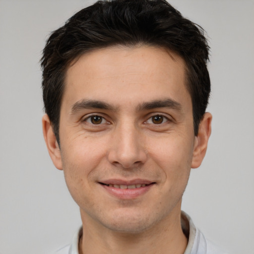 Joyful white young-adult male with short  brown hair and brown eyes