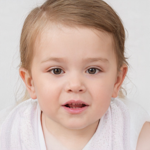 Joyful white child female with short  brown hair and blue eyes