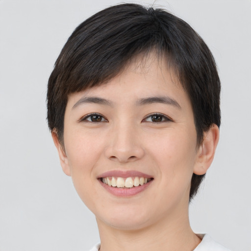 Joyful asian young-adult female with short  brown hair and brown eyes